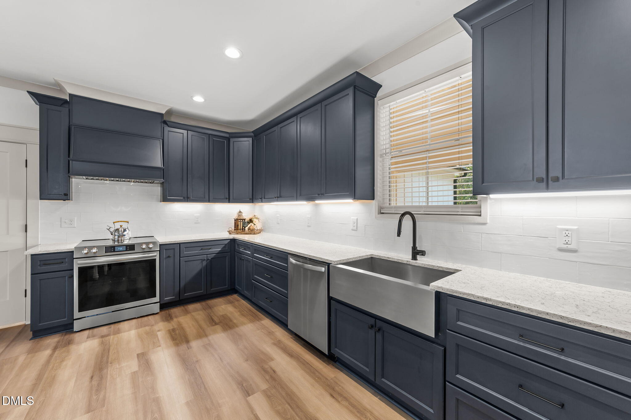 582 Harnett Central Road Fuquay-Varina, NC 27526 - Photo 31 of 51 a kitchen with a sink stove top oven and cabinets