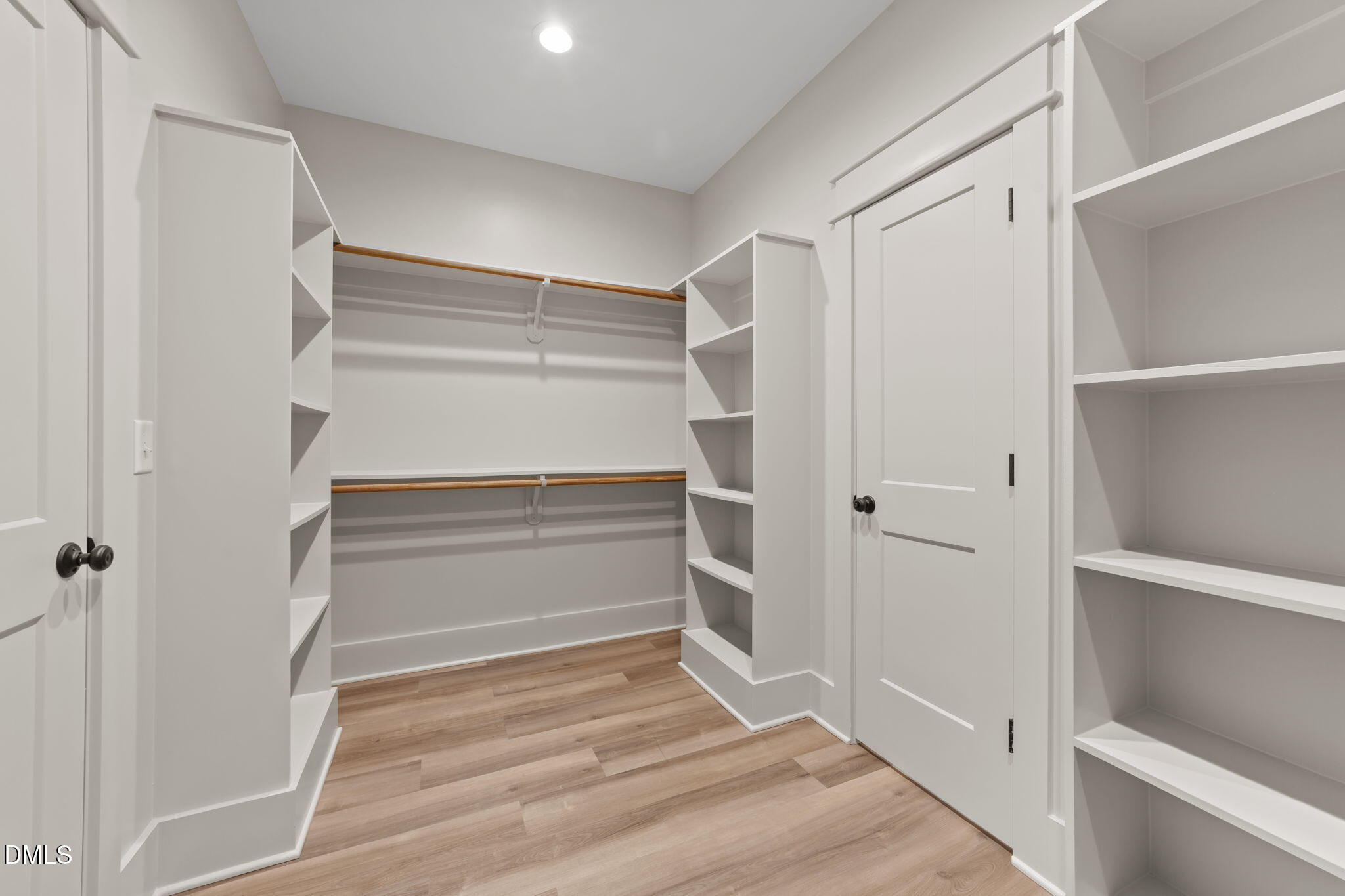 582 Harnett Central Road Fuquay-Varina, NC 27526 - Photo 44 of 51 a view of walk in closet with empty racks