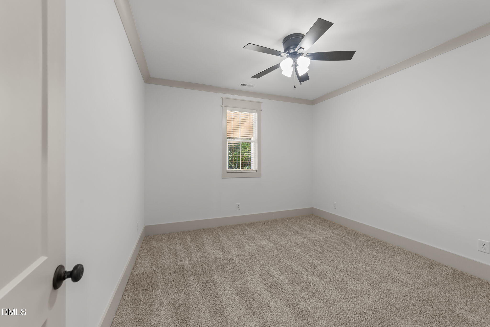 582 Harnett Central Road Fuquay-Varina, NC 27526 - Photo 50 of 51 an empty room with chandelier fan and windows