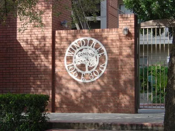 a view of a brick wall with a small garden