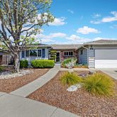 a view of a house with swimming pool and sitting area