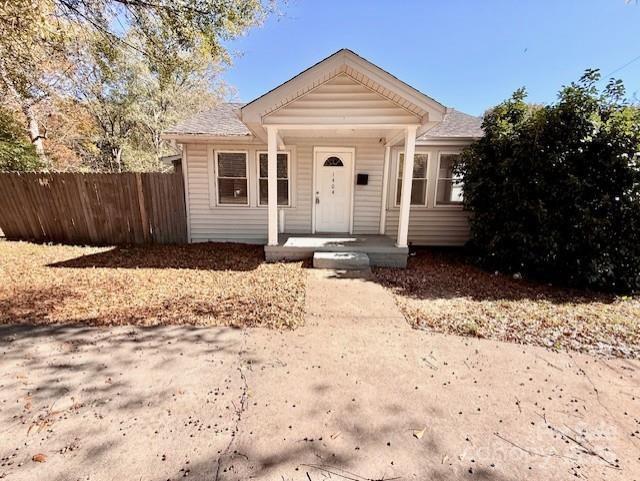 a front view of a house with a yard covered in snow