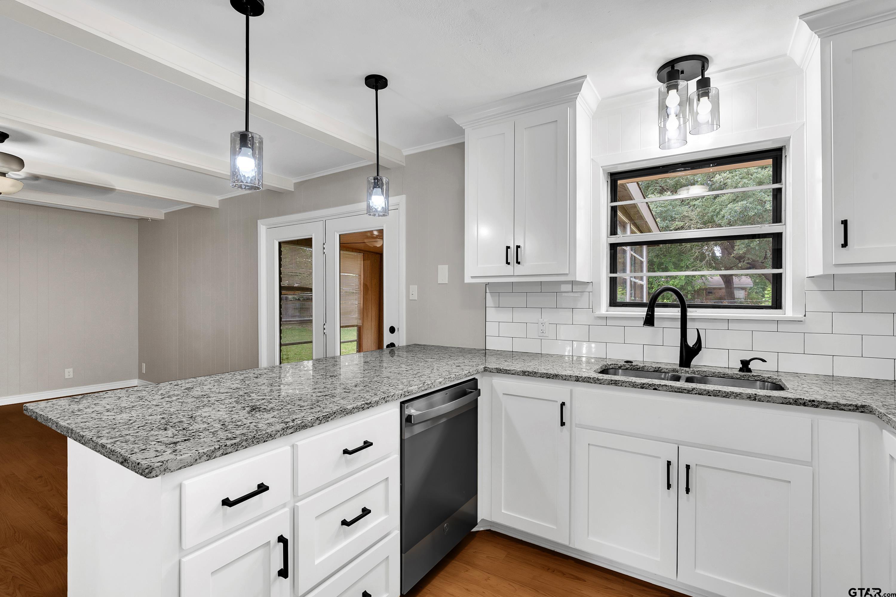 12813 Sunset Drive Tyler, TX 75704 - Photo 14 of 34 a kitchen with granite countertop a sink cabinets and window