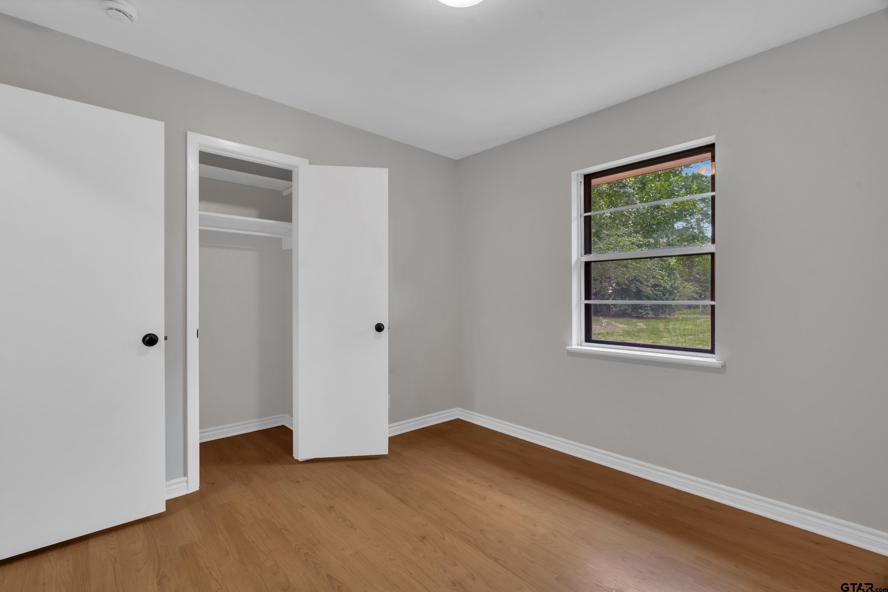 12813 Sunset Drive Tyler, TX 75704 - Photo 19 of 34 a view of an empty room with closet and a window