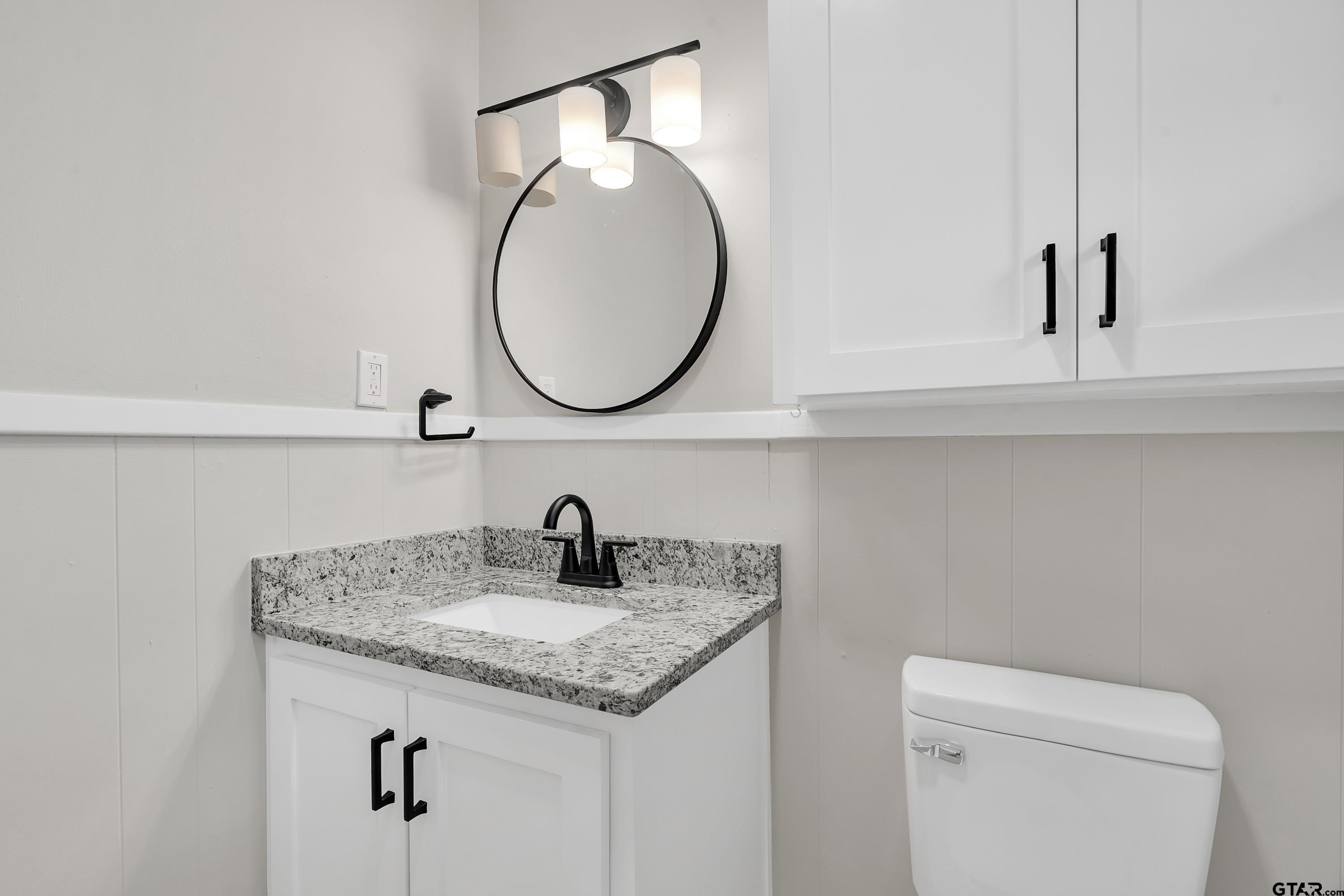 12813 Sunset Drive Tyler, TX 75704 - Photo 22 of 34 a bathroom with a granite countertop sink and a mirror