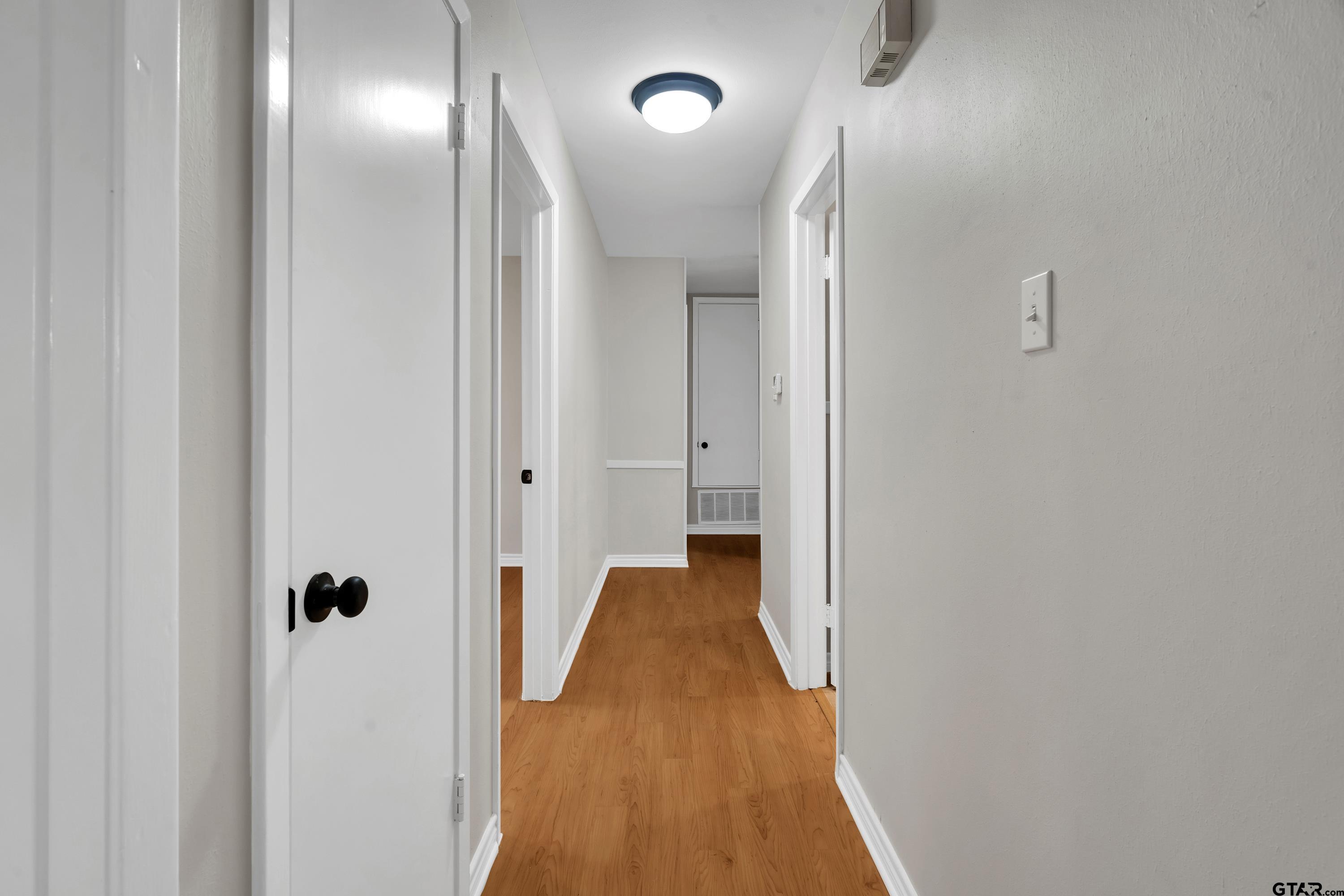 12813 Sunset Drive Tyler, TX 75704 - Photo 24 of 34 a view of a hallway with wooden floor