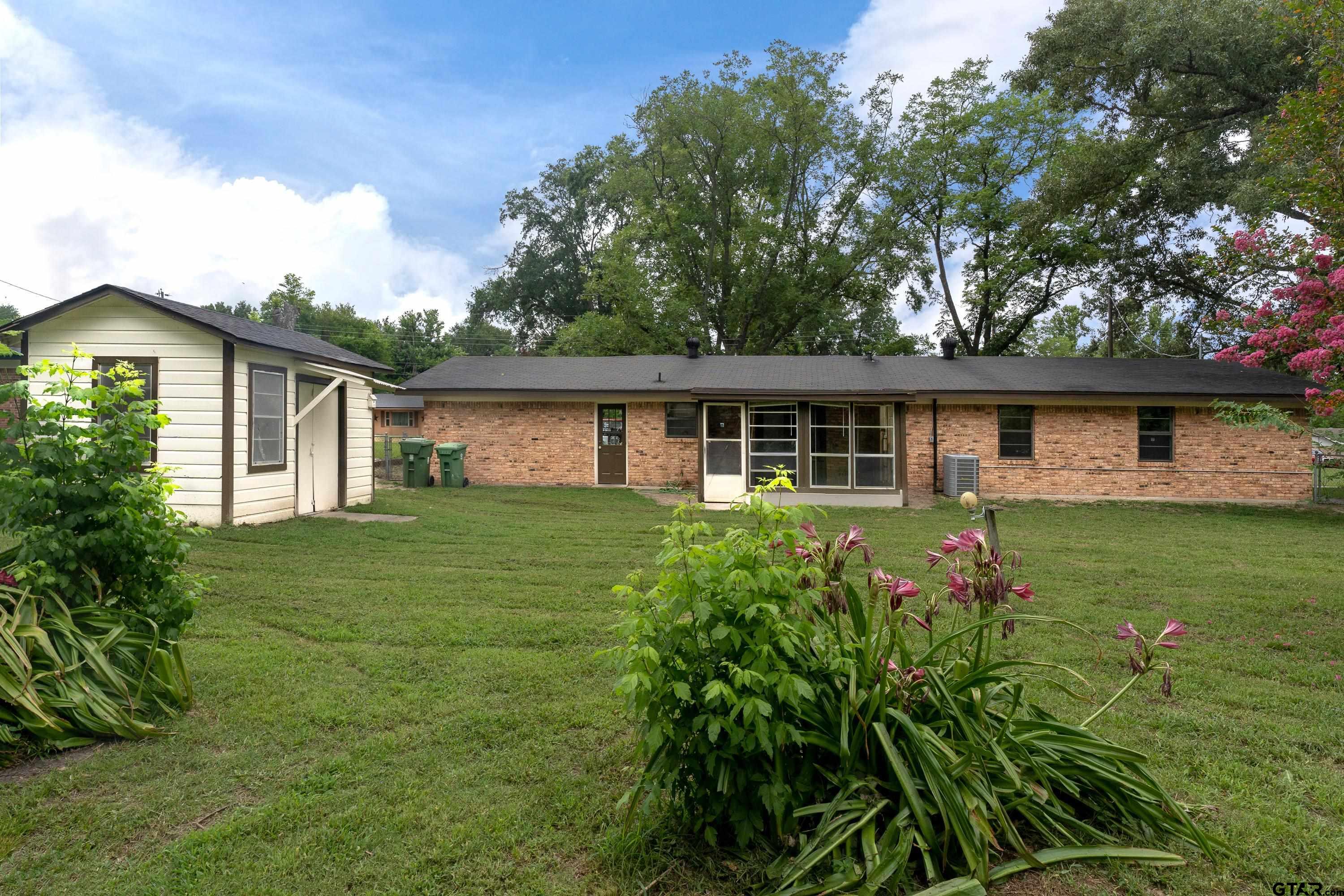 12813 Sunset Drive Tyler, TX 75704 - Photo 29 of 34 a front view of house with yard and green space