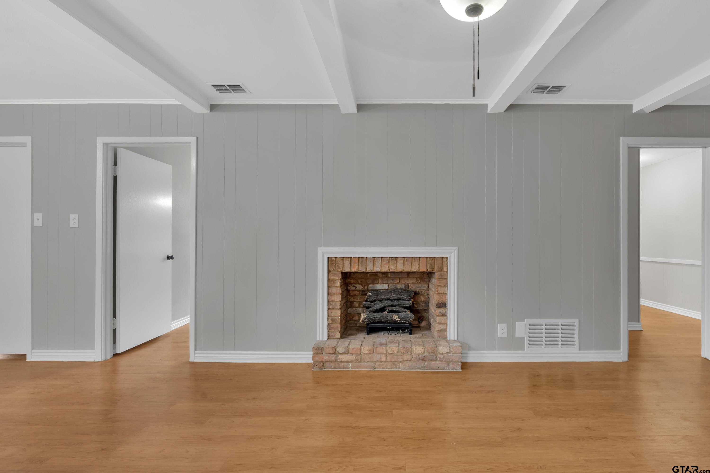 12813 Sunset Drive Tyler, TX 75704 - Photo 8 of 34 a view of an empty room with wooden floor and a window