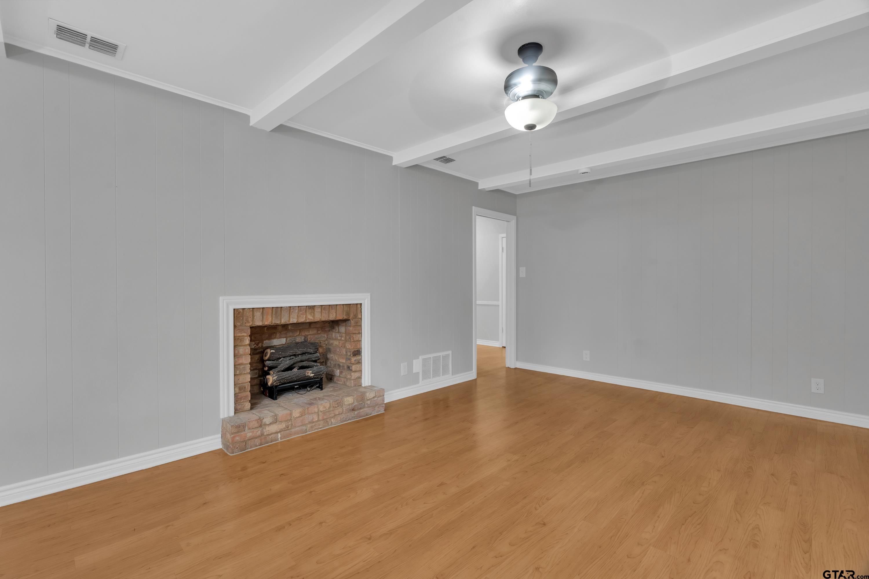 12813 Sunset Drive Tyler, TX 75704 - Photo 9 of 34 a view of an empty room with a ceiling fan and a window
