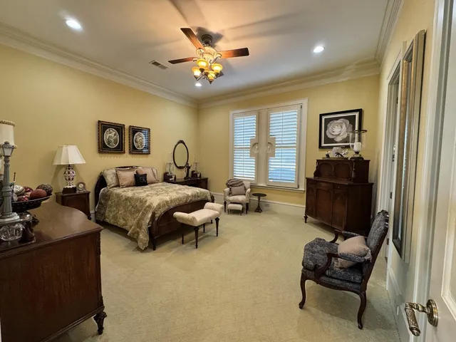 a bedroom with bed couch and window