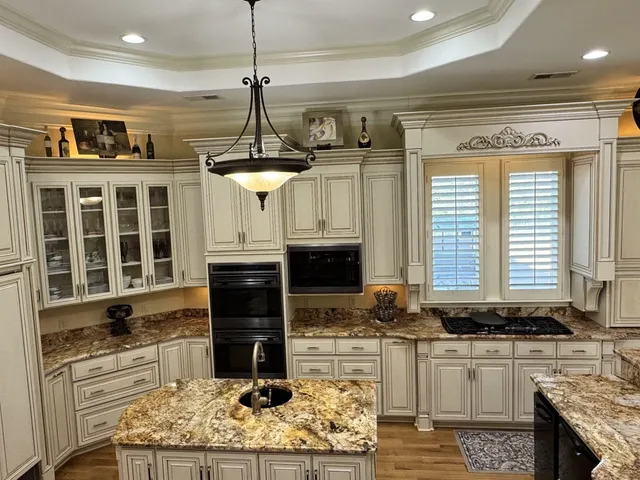 a kitchen with stainless steel appliances granite countertop a stove and cabinets