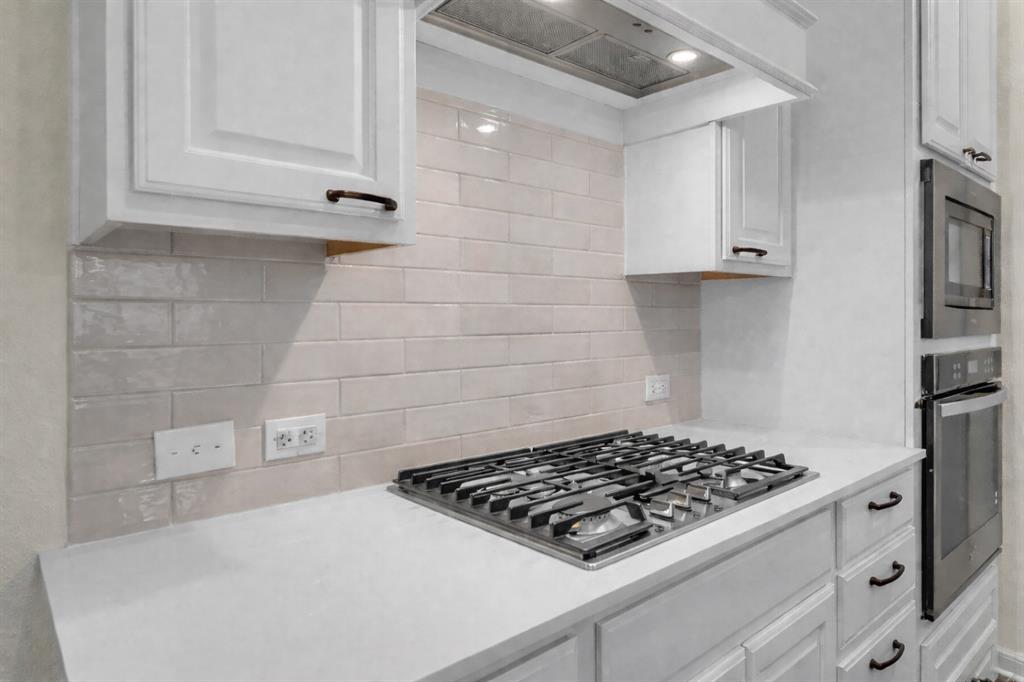 3106 Maverick Drive Forney, TX 75126 - Photo 12 of 32 a stove top oven sitting inside of a kitchen