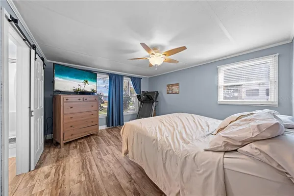 a bedroom with a bed and wooden floor