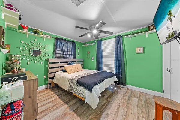 a bedroom with a large bed and a chandelier