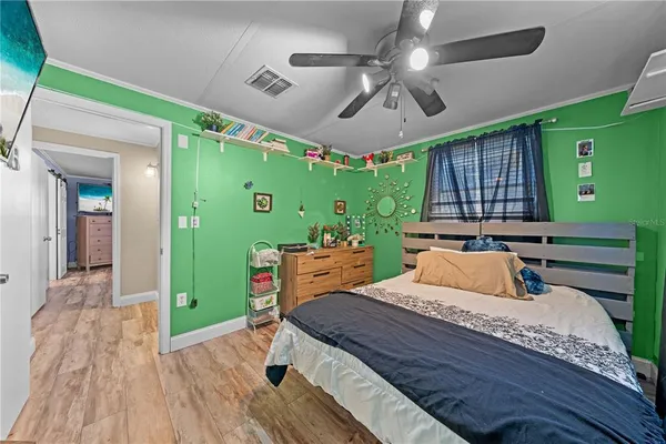 a living room with furniture refrigerator and a kitchen view