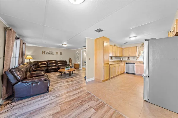 a kitchen with stainless steel appliances granite countertop a stove sink microwave and window