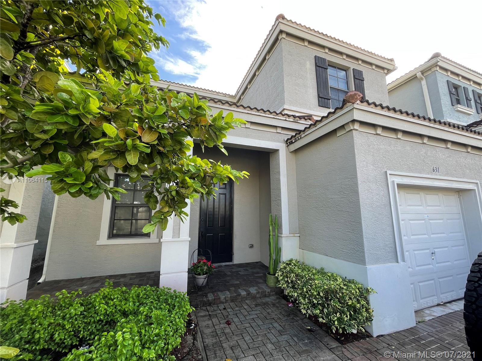 631 Northeast 191st Terrace Miami, FL 33179 - Photo 2 of 28 a front view of a house with garden