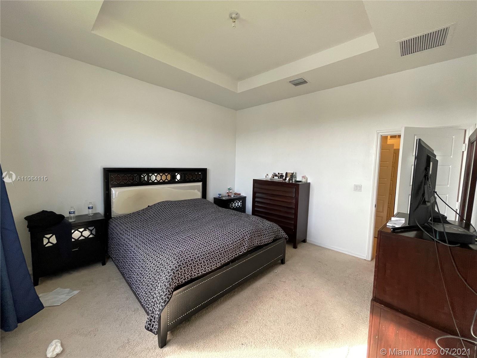 631 Northeast 191st Terrace Miami, FL 33179 - Photo 11 of 28 a bedroom with a bed and dresser