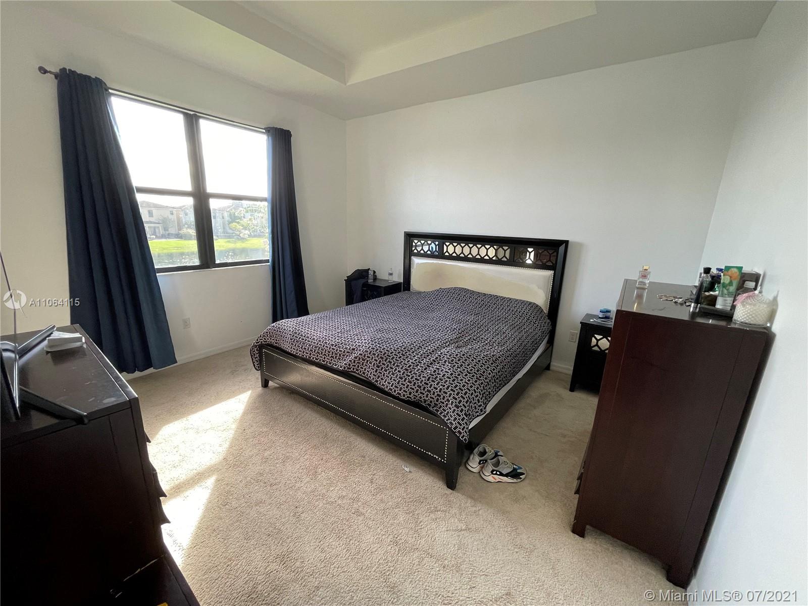 631 Northeast 191st Terrace Miami, FL 33179 - Photo 12 of 28 a bedroom with a bed and window
