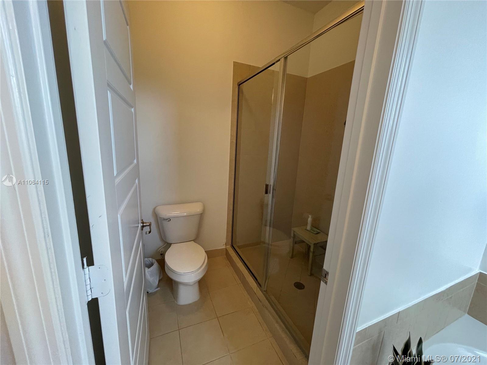 631 Northeast 191st Terrace Miami, FL 33179 - Photo 15 of 28 a bathroom with a toilet and a shower