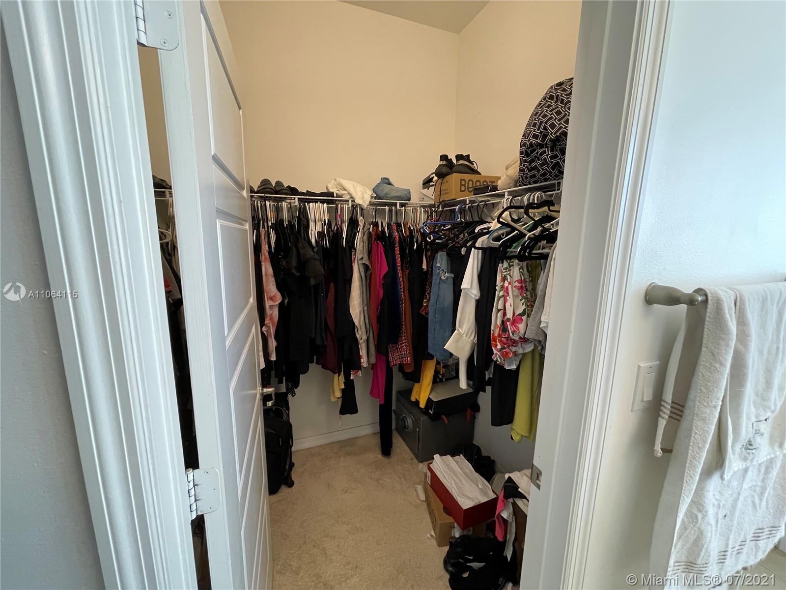 631 Northeast 191st Terrace Miami, FL 33179 - Photo 16 of 28 a view of walk in closet with clothes and shoes