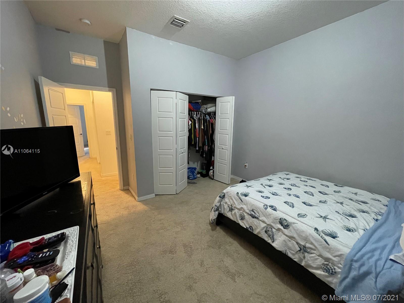 631 Northeast 191st Terrace Miami, FL 33179 - Photo 19 of 28 a bedroom with a bed and a window