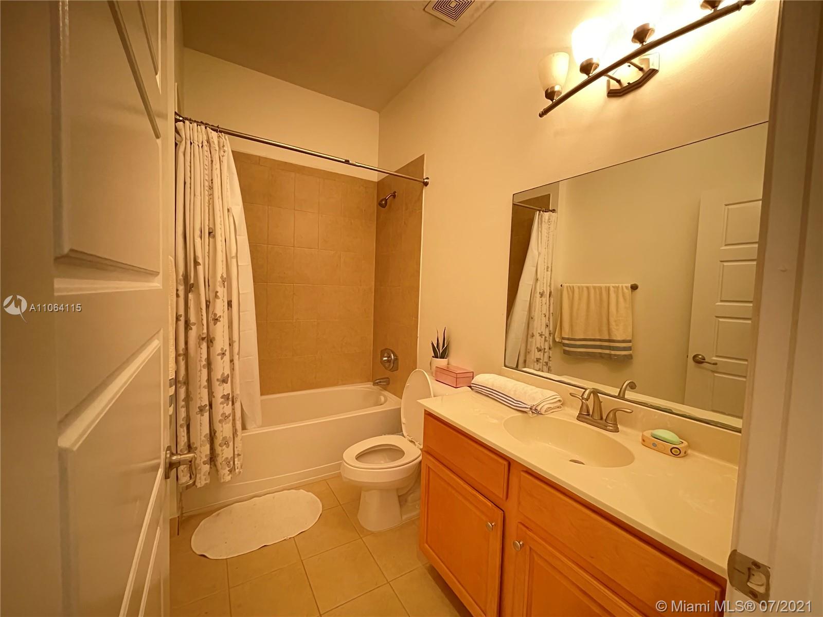631 Northeast 191st Terrace Miami, FL 33179 - Photo 21 of 28 a bathroom with a granite countertop sink toilet and shower