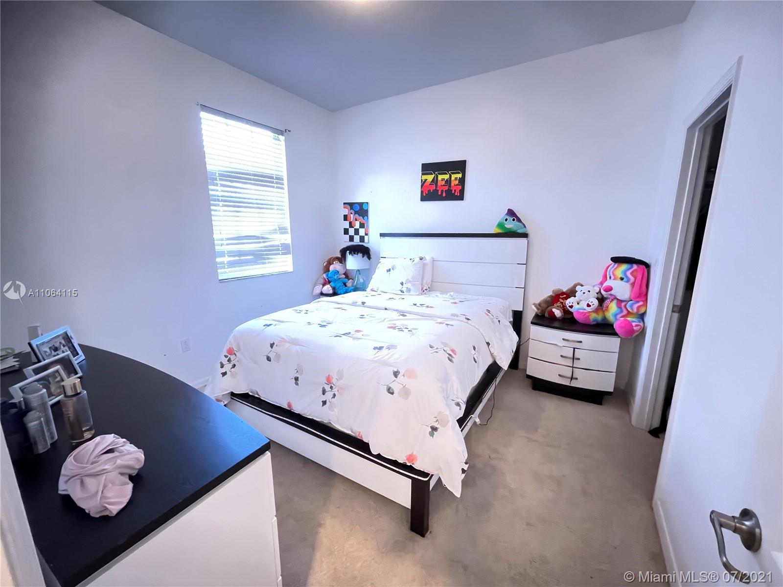 631 Northeast 191st Terrace Miami, FL 33179 - Photo 22 of 28 a bedroom with a bed and a window