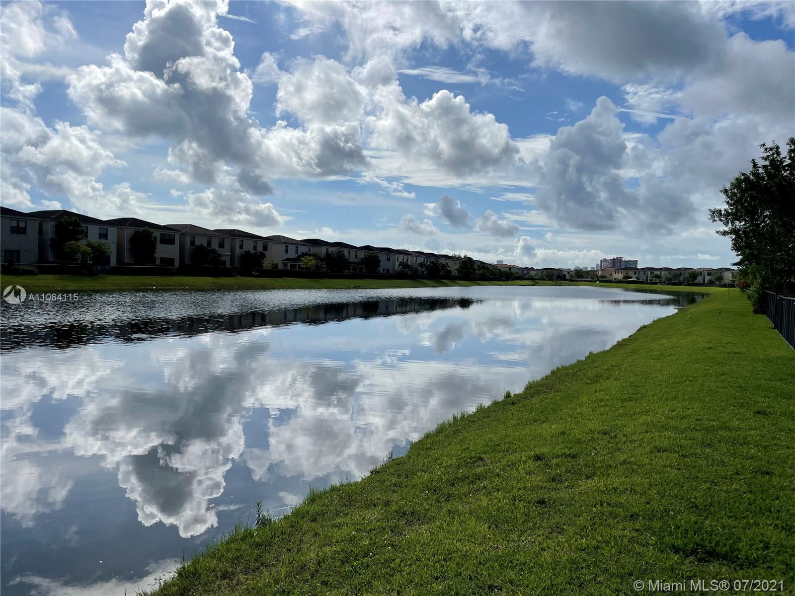 631 Northeast 191st Terrace Miami, FL 33179 - Photo 24 of 28 a view of a lake with houses in the back