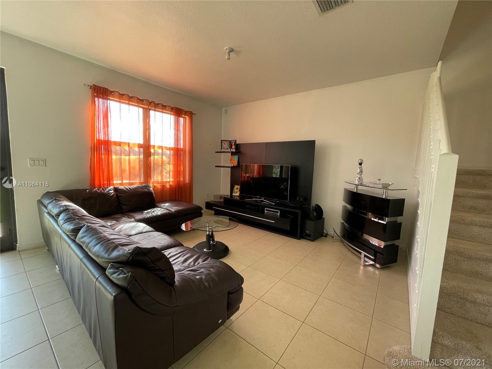 631 Northeast 191st Terrace Miami, FL 33179 - Photo 8 of 28 a living room with furniture and a flat screen tv
