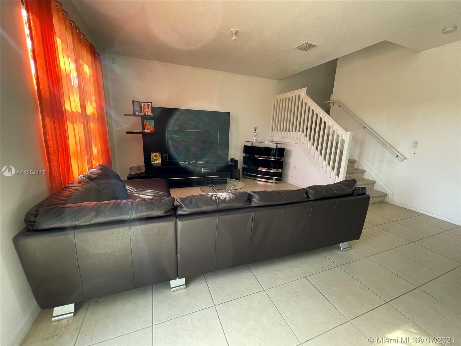 631 Northeast 191st Terrace Miami, FL 33179 - Photo 9 of 28 a living room with stainless steel appliances kitchen island granite countertop a rug and a window