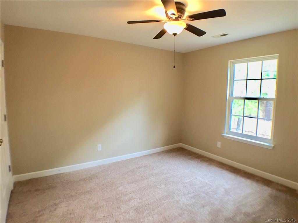 2543 Captains Watch Road Northeast Kannapolis, NC 28083 - Photo 12 of 17 an empty room with windows and fan