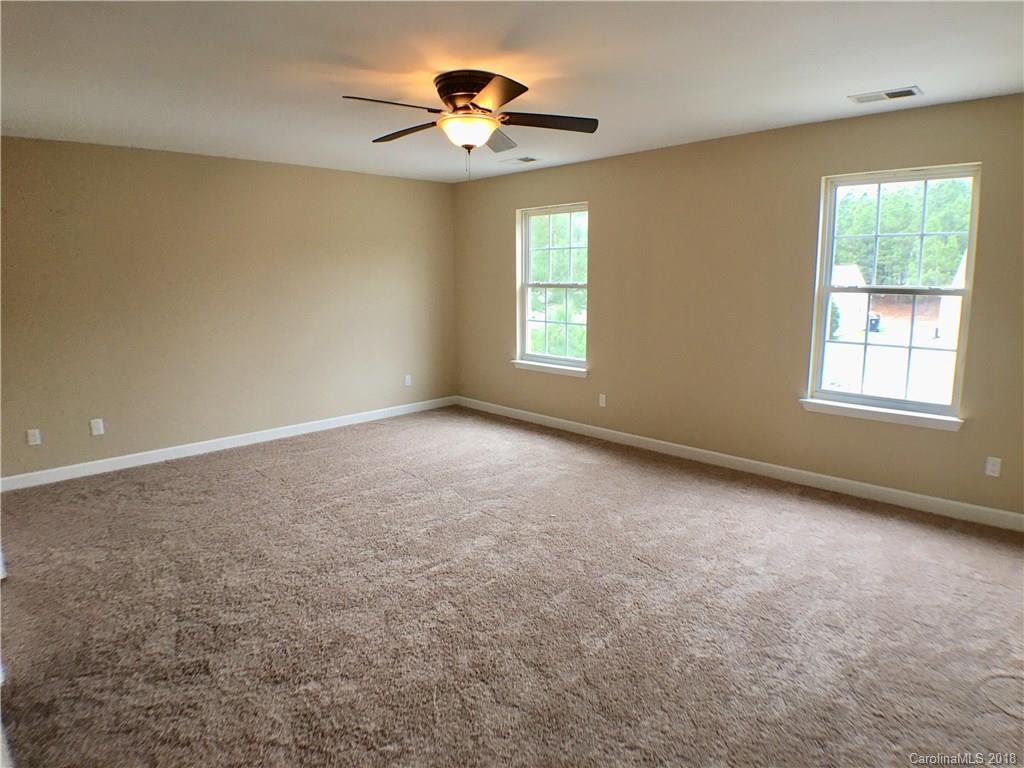 2543 Captains Watch Road Northeast Kannapolis, NC 28083 - Photo 13 of 17 an empty room with windows and chandelier fan