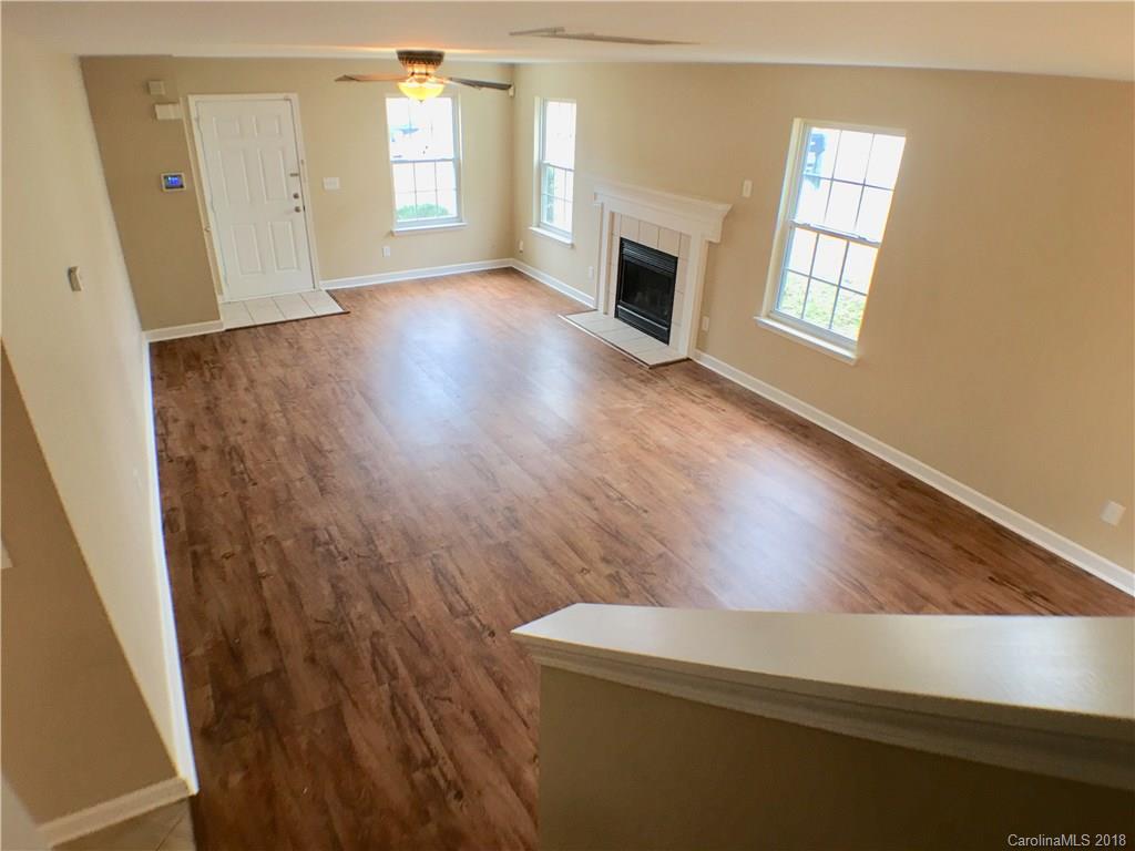 2543 Captains Watch Road Northeast Kannapolis, NC 28083 - Photo 5 of 17 a view of an empty room with wooden floor and a window