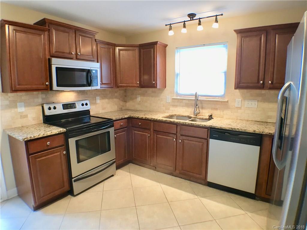 2543 Captains Watch Road Northeast Kannapolis, NC 28083 - Photo 7 of 17 a kitchen with stainless steel appliances granite countertop a stove microwave and sink