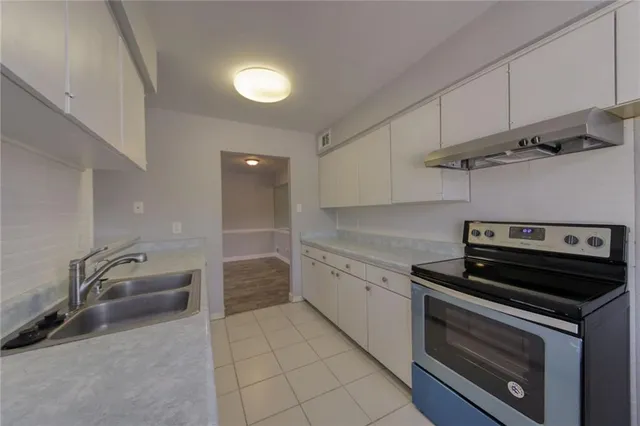 a kitchen that has a sink and a stove