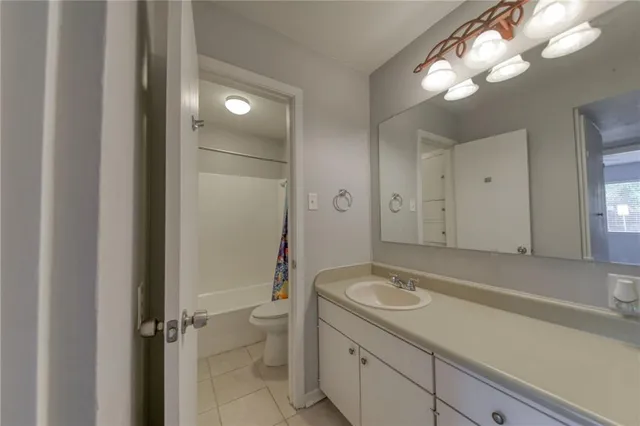 a bathroom with a sink a light fixture and a mirror