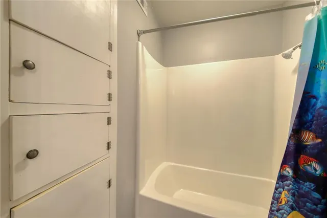 a bathroom with a shower and a bath tub