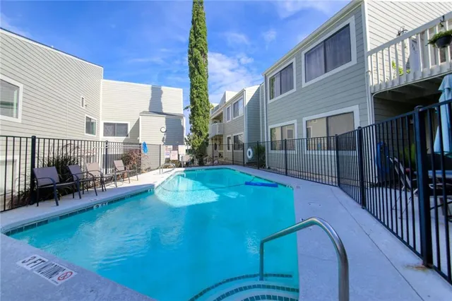 a swimming pool with outdoor seating and yard