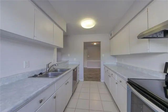 a kitchen with a sink and cabinets
