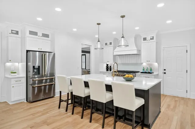 a kitchen with kitchen island a sink and wooden floor