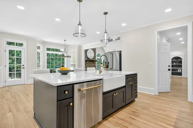 a kitchen with white cabinets and appliances