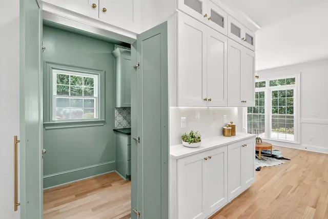 a kitchen with granite countertop a sink stove and cabinets