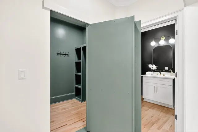 a spacious bathroom with a double vanity sink a large mirror and a bathtub next to a window