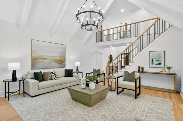 a living room with furniture or chandelier and a rug