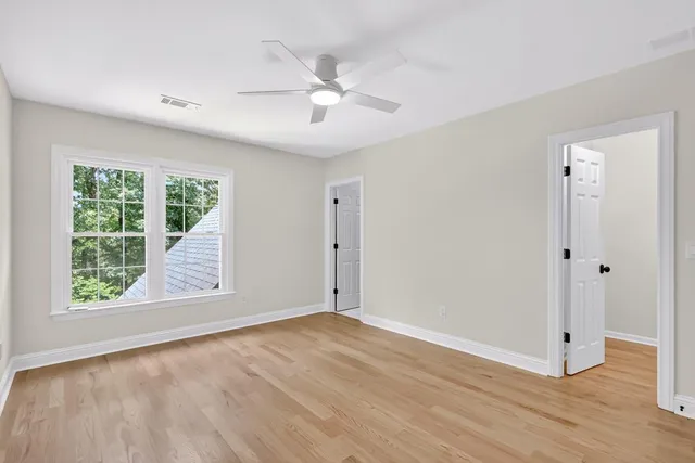 a bathroom with a sink a toilet and a large mirror