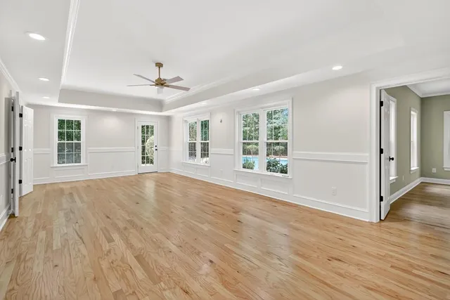 a view of a kitchen with cabinets and wooden floor