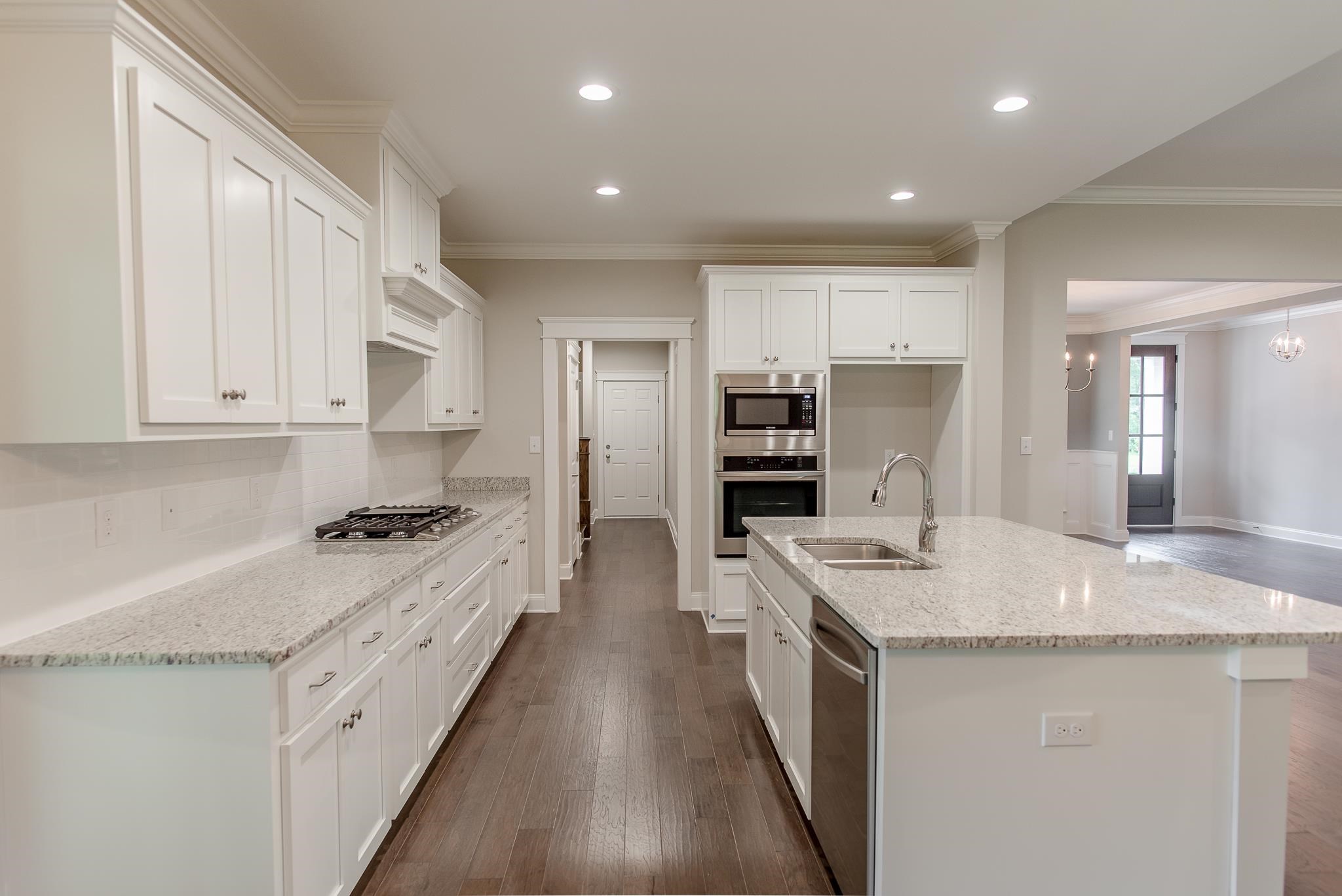 2845 Trestle Way Cantonment, FL 32533 - Photo 3 of 5 a large kitchen with stainless steel appliances granite countertop a lot of counter space and wooden floors