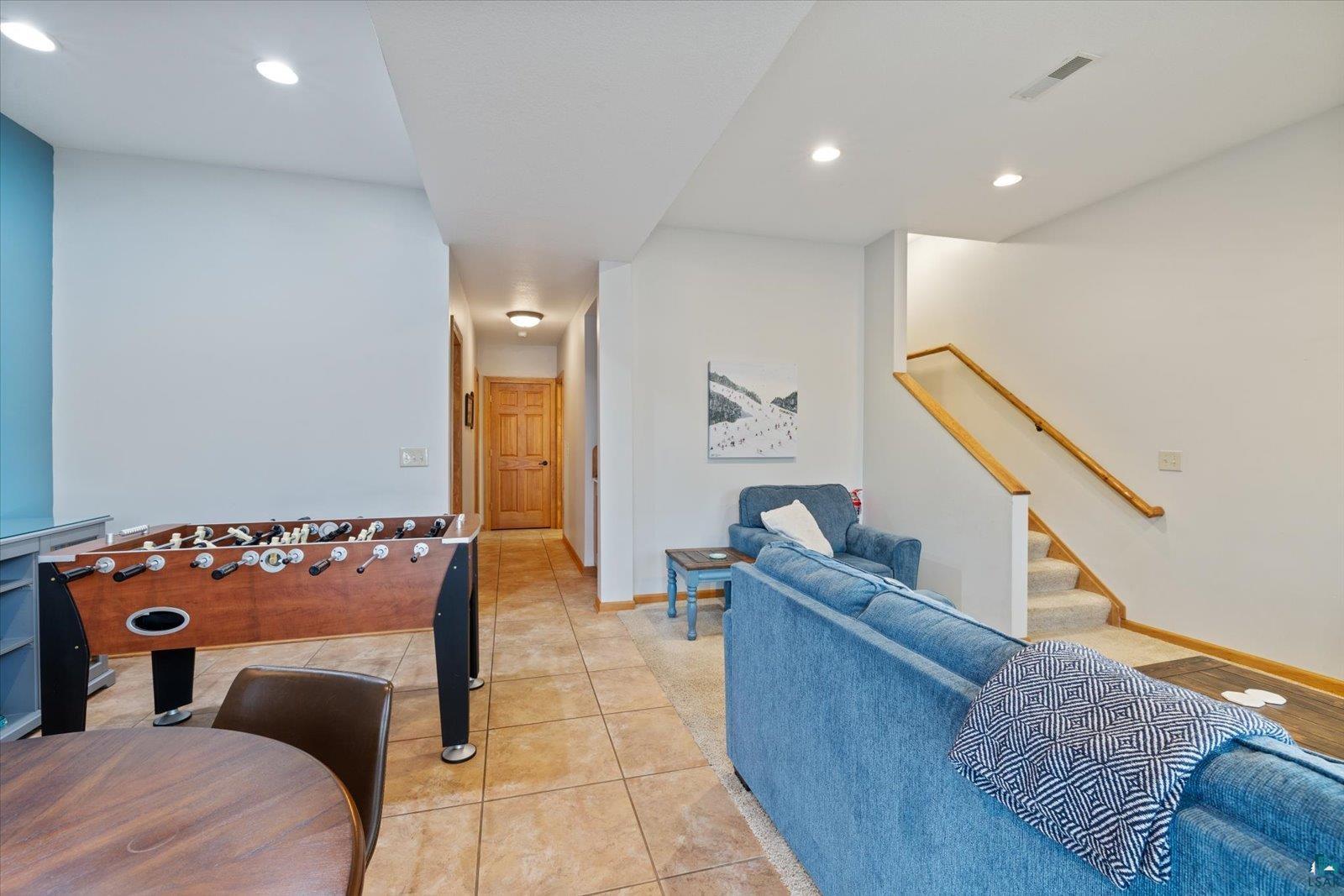 6266 Giants Ridge Road Biwabik, MN 55705 - Photo 17 of 37 Recessed lighting illuminates the tiled flooring and staircase with wood handrails