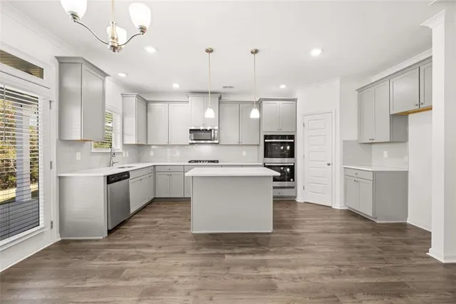 a kitchen with a white cabinets and window
